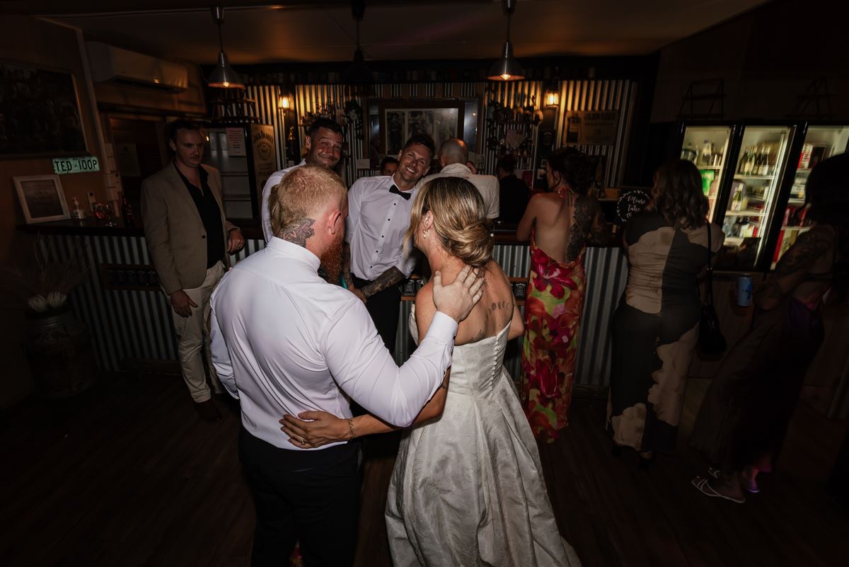 Newlyweds dancing in the bar at night