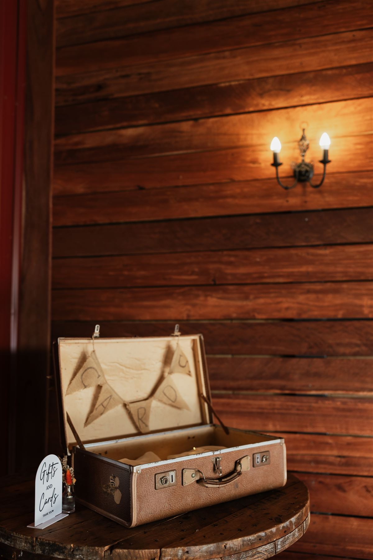Vintage suitcase for gifts and cards on a barrel table